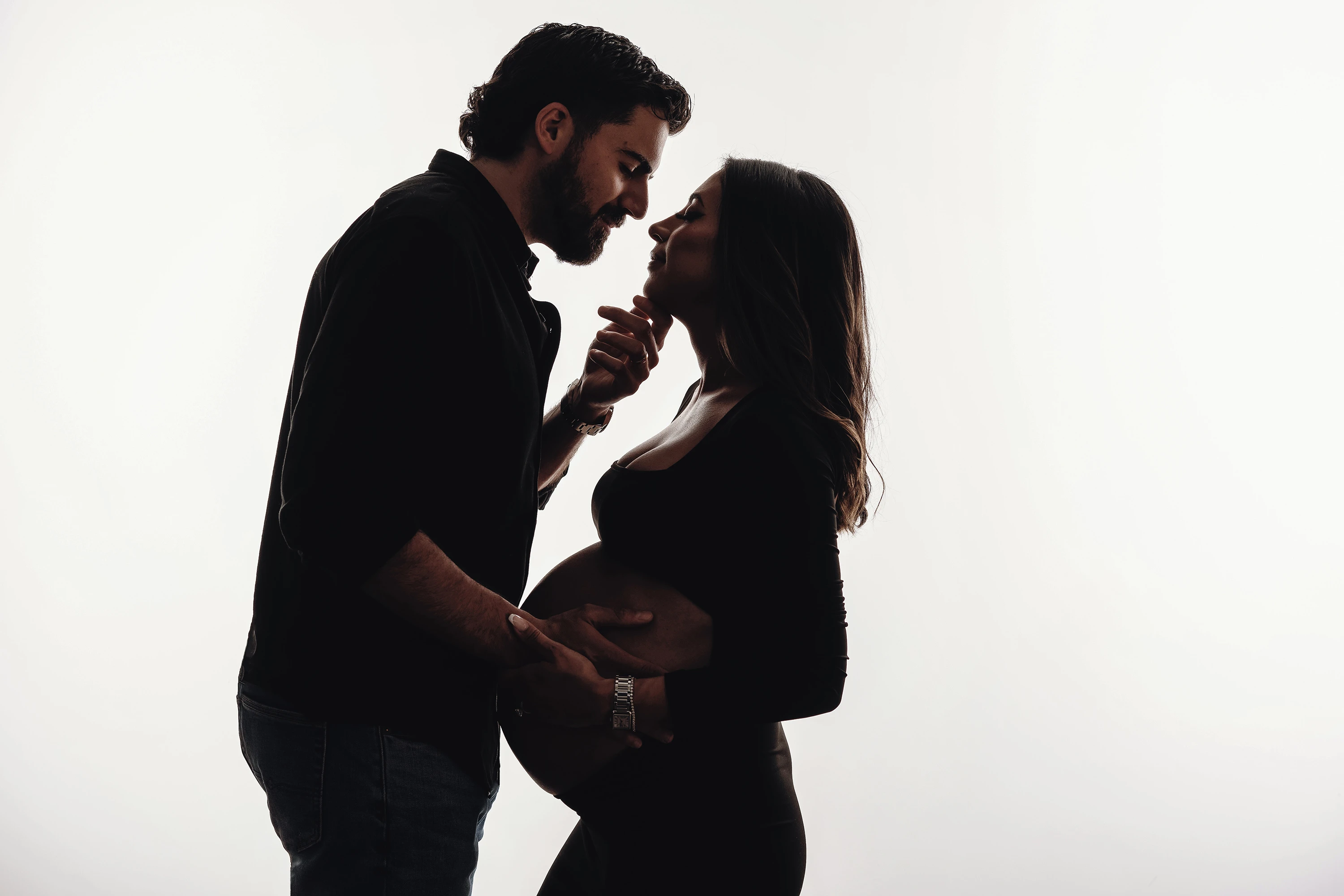 close up of man and woman kissing maternity photo