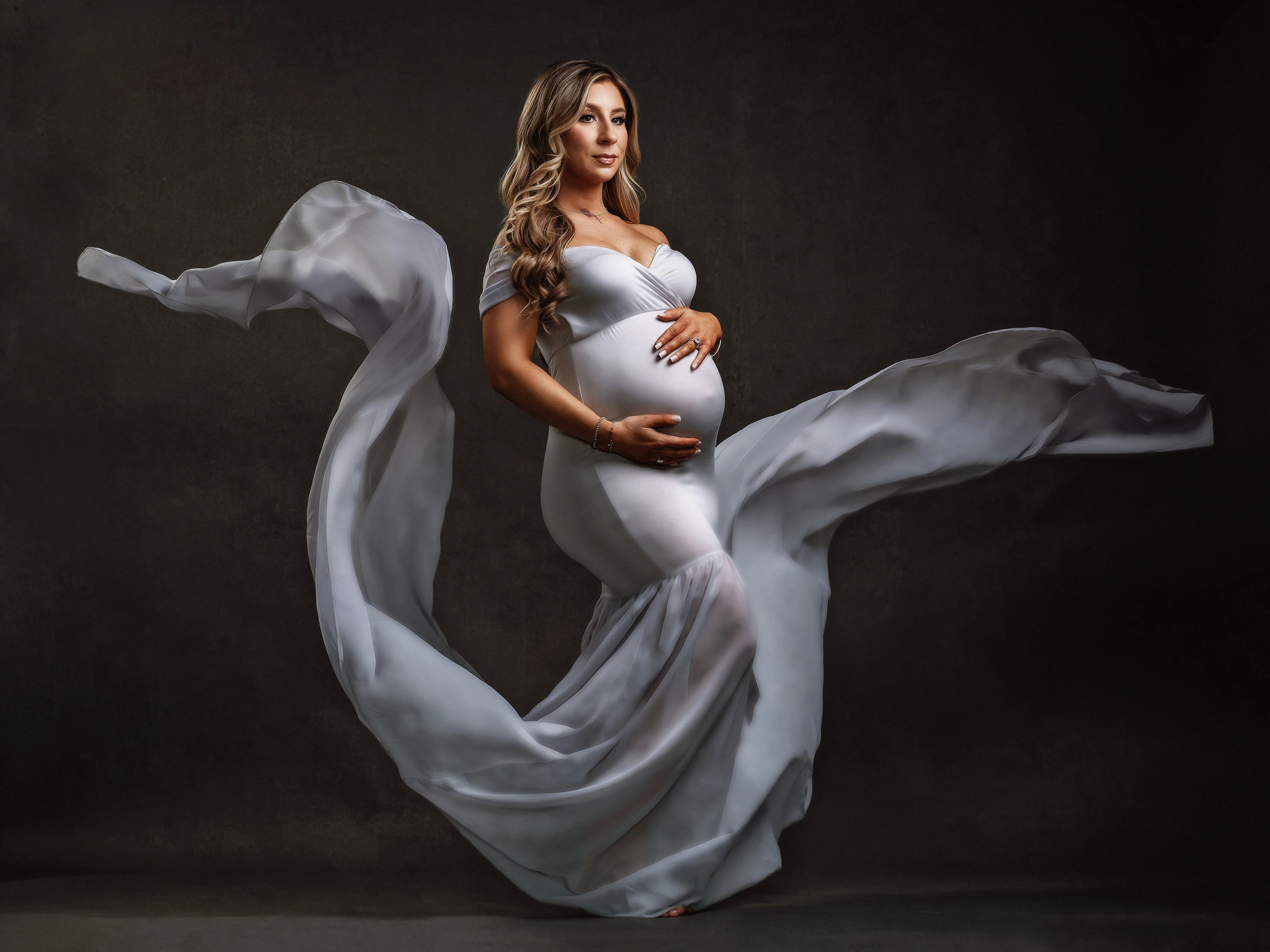 maternity photo of woman holding her stomach