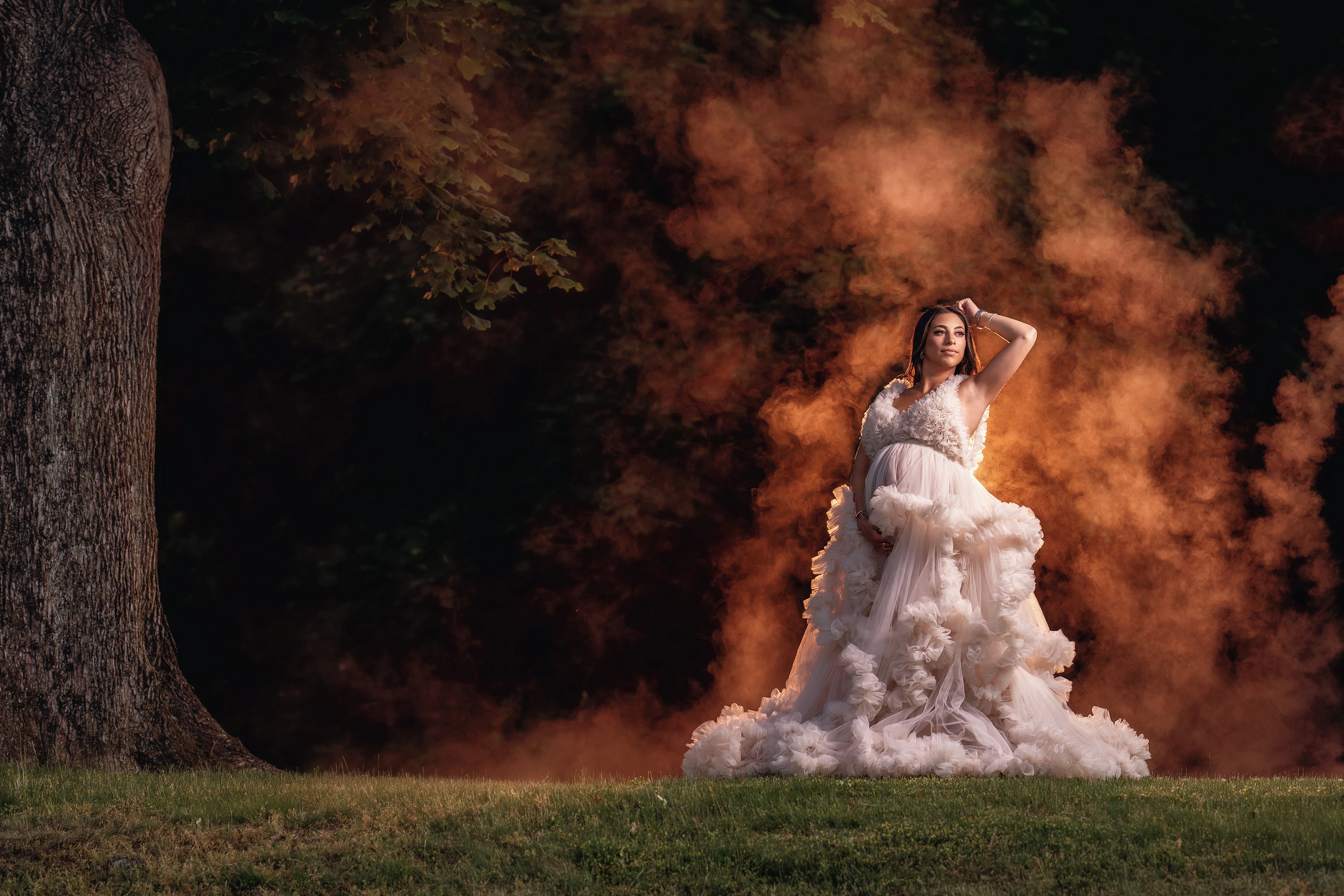 maternity photo of woman in gown posing outdoors