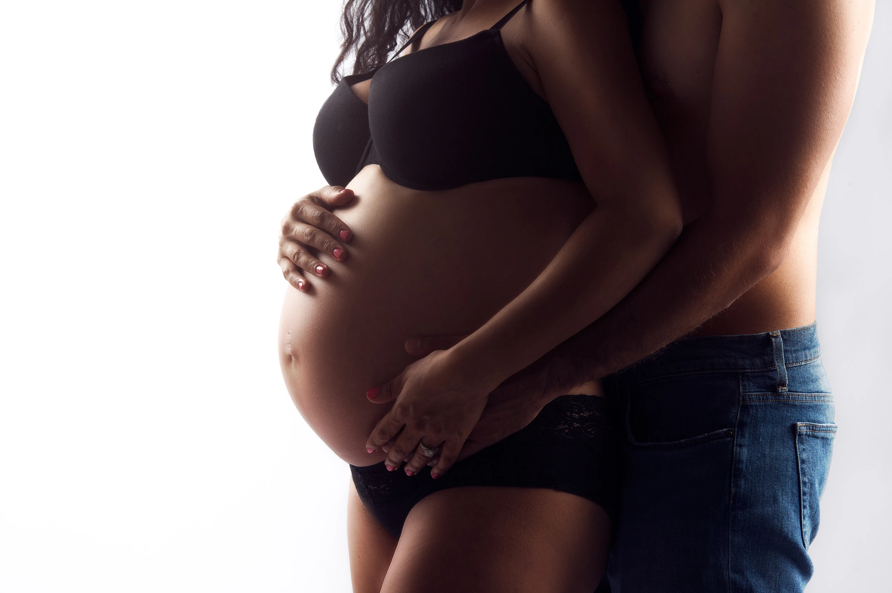 close up maternity photo of man holding woman's stomach