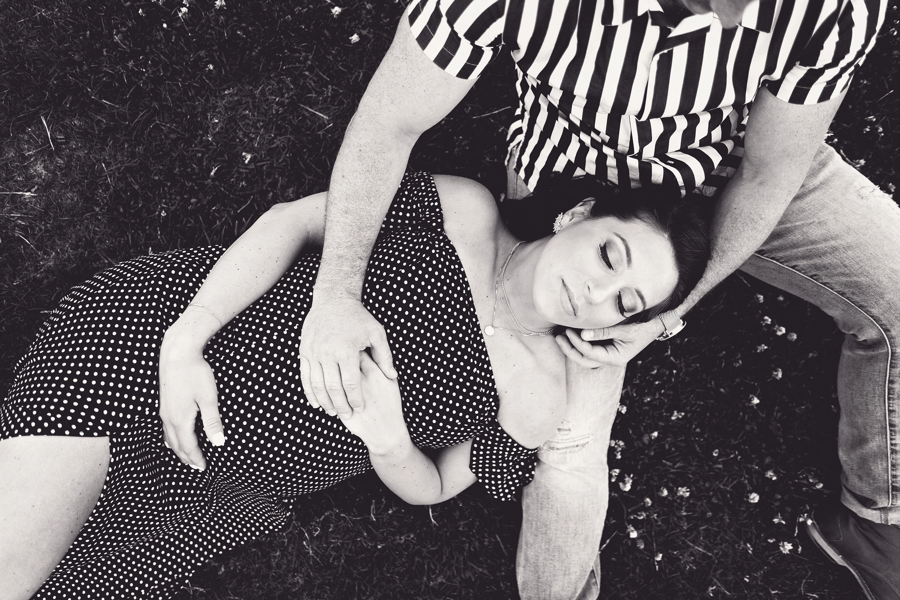 pregnant woman laying on her husband's leg