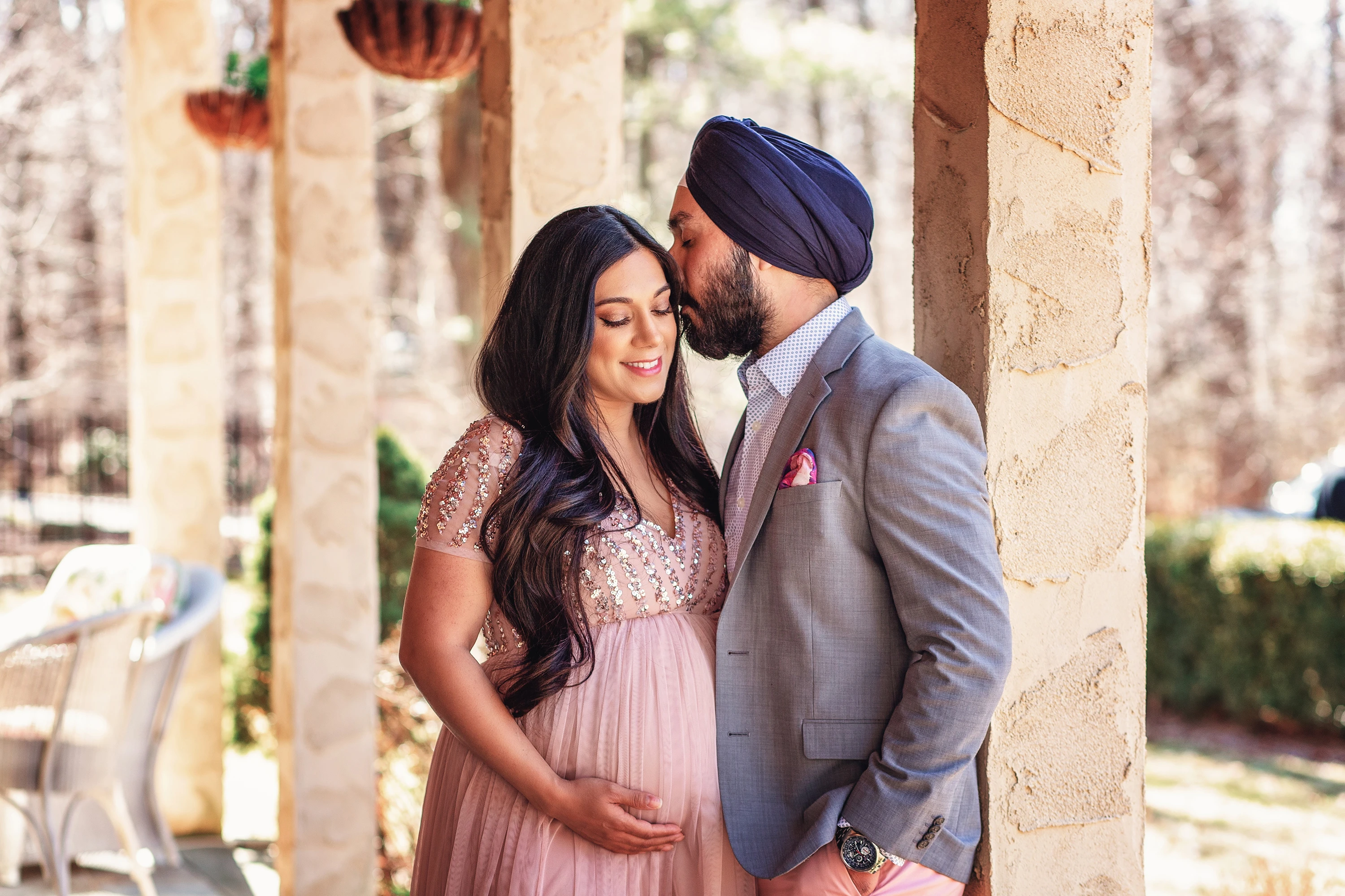 maternity photo of man kissing his wife