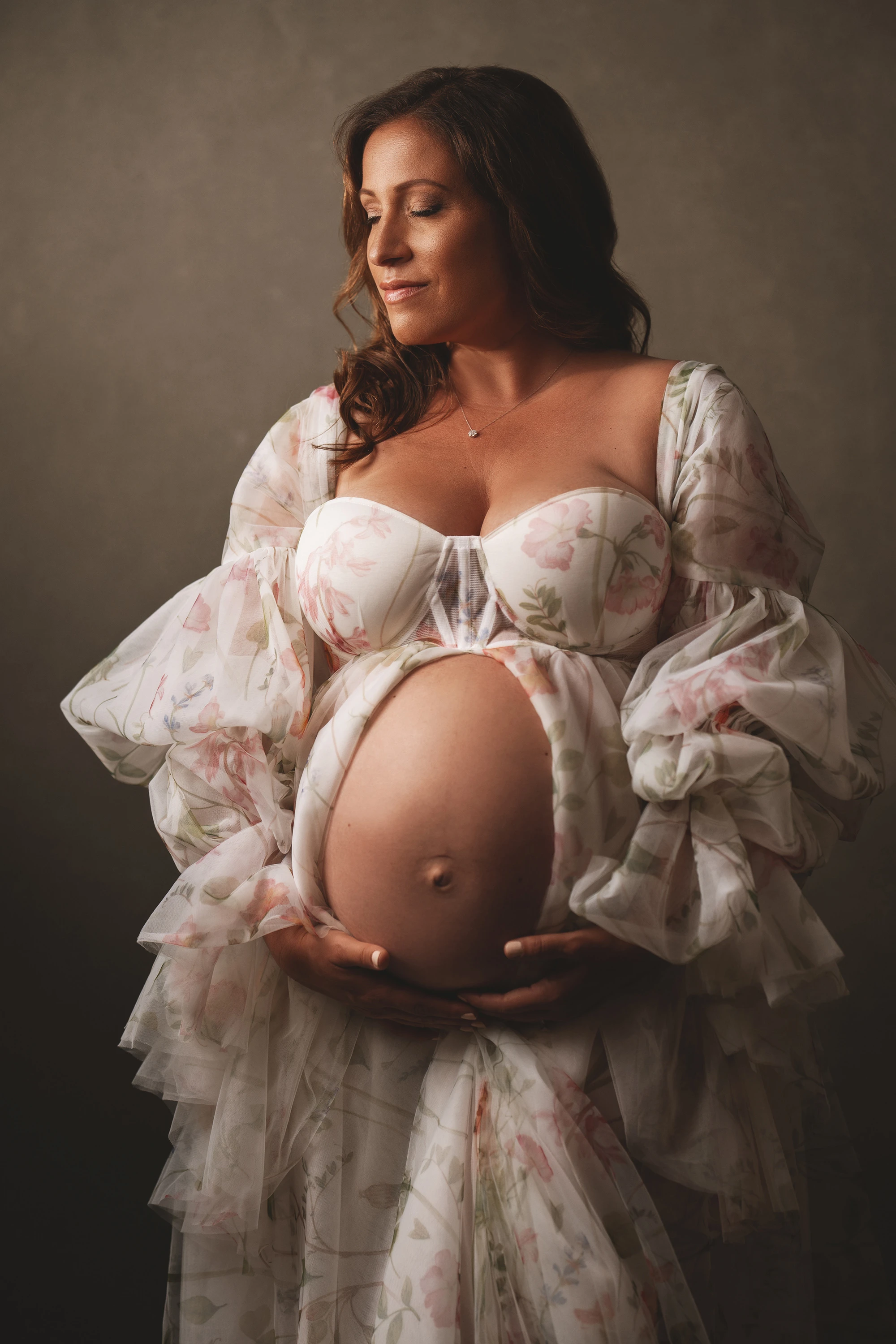 maternity photo of woman holding her belly