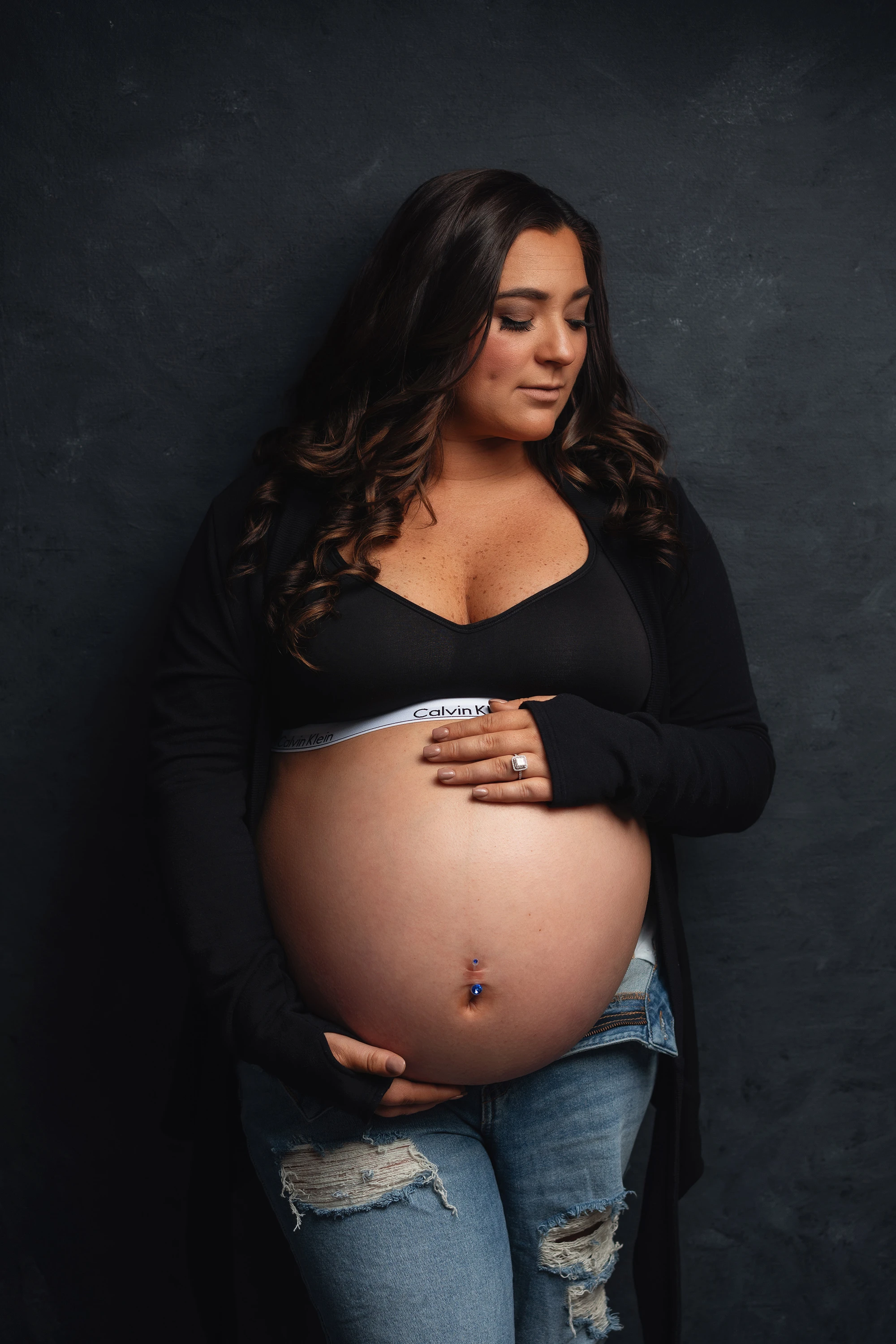 maternity photo of woman holding her belly