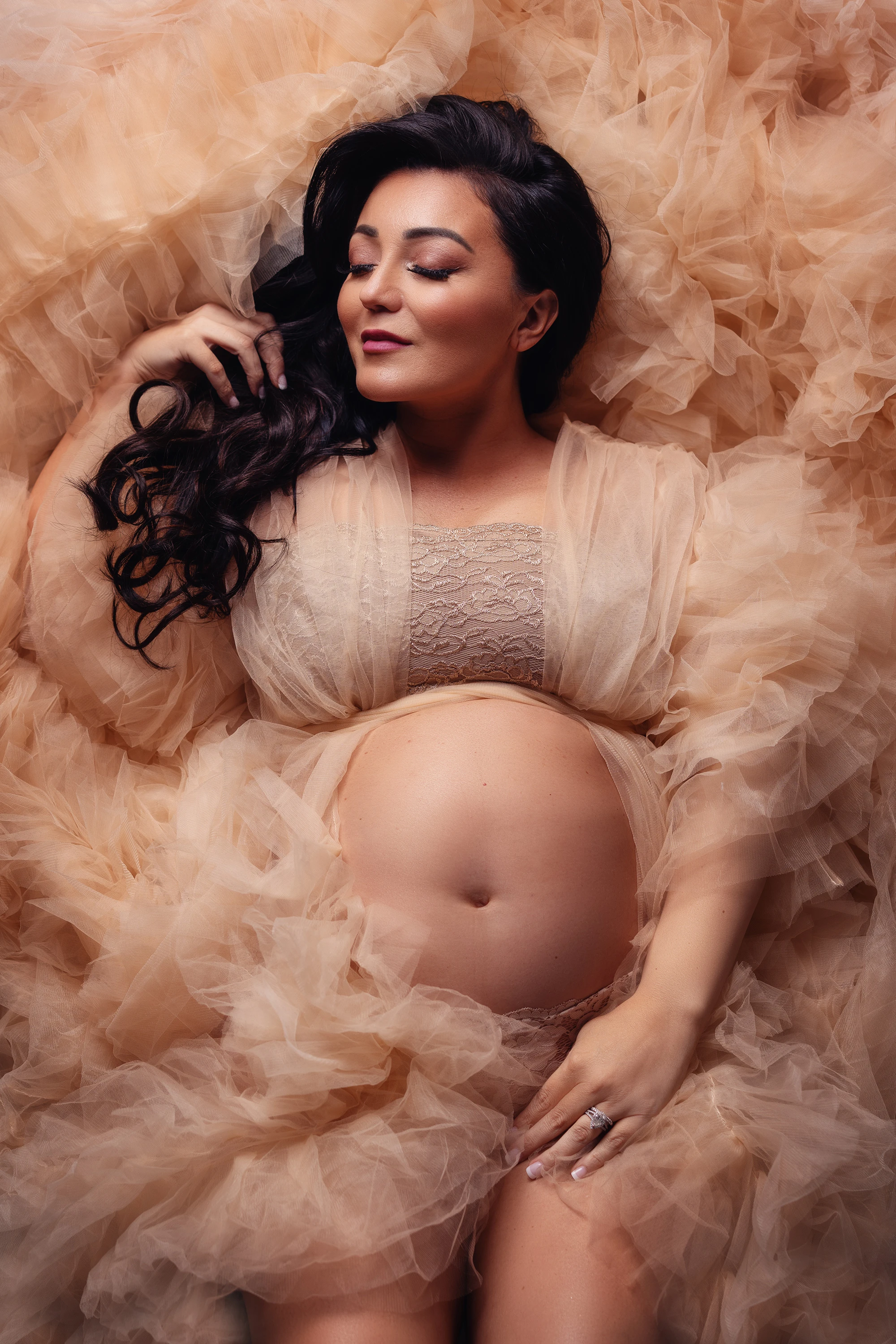 maternity photo of woman laying down