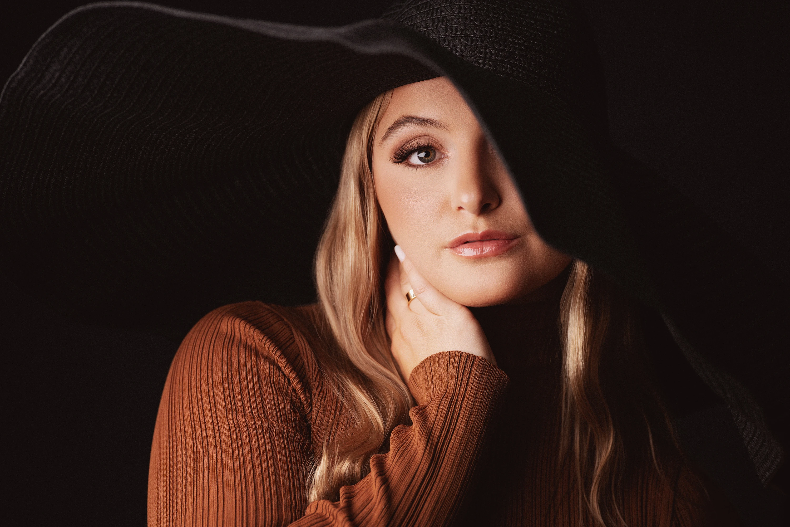 close up photo of woman wearing black hat
