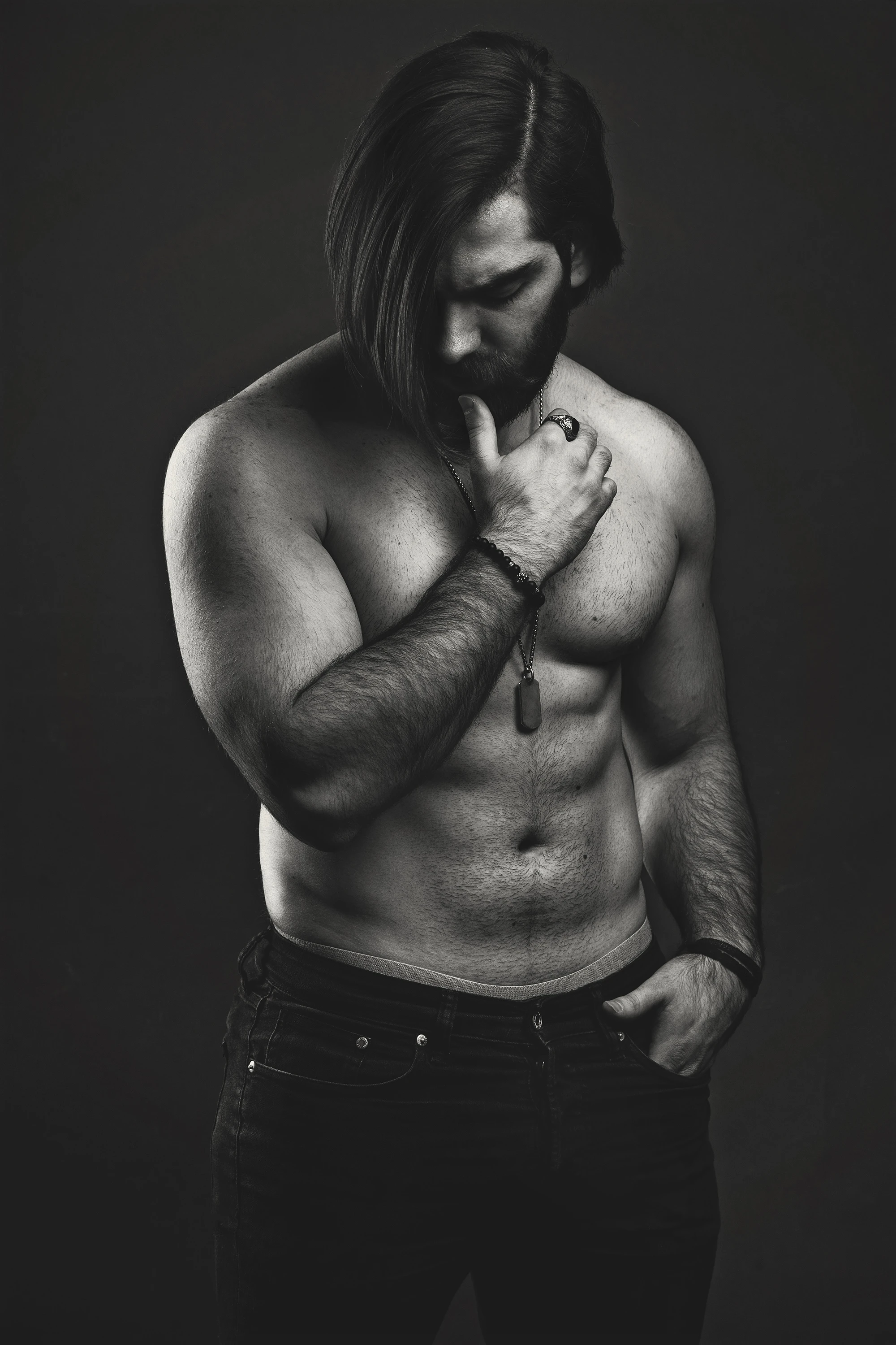 creative portrait of man posing with no shirt in black and white