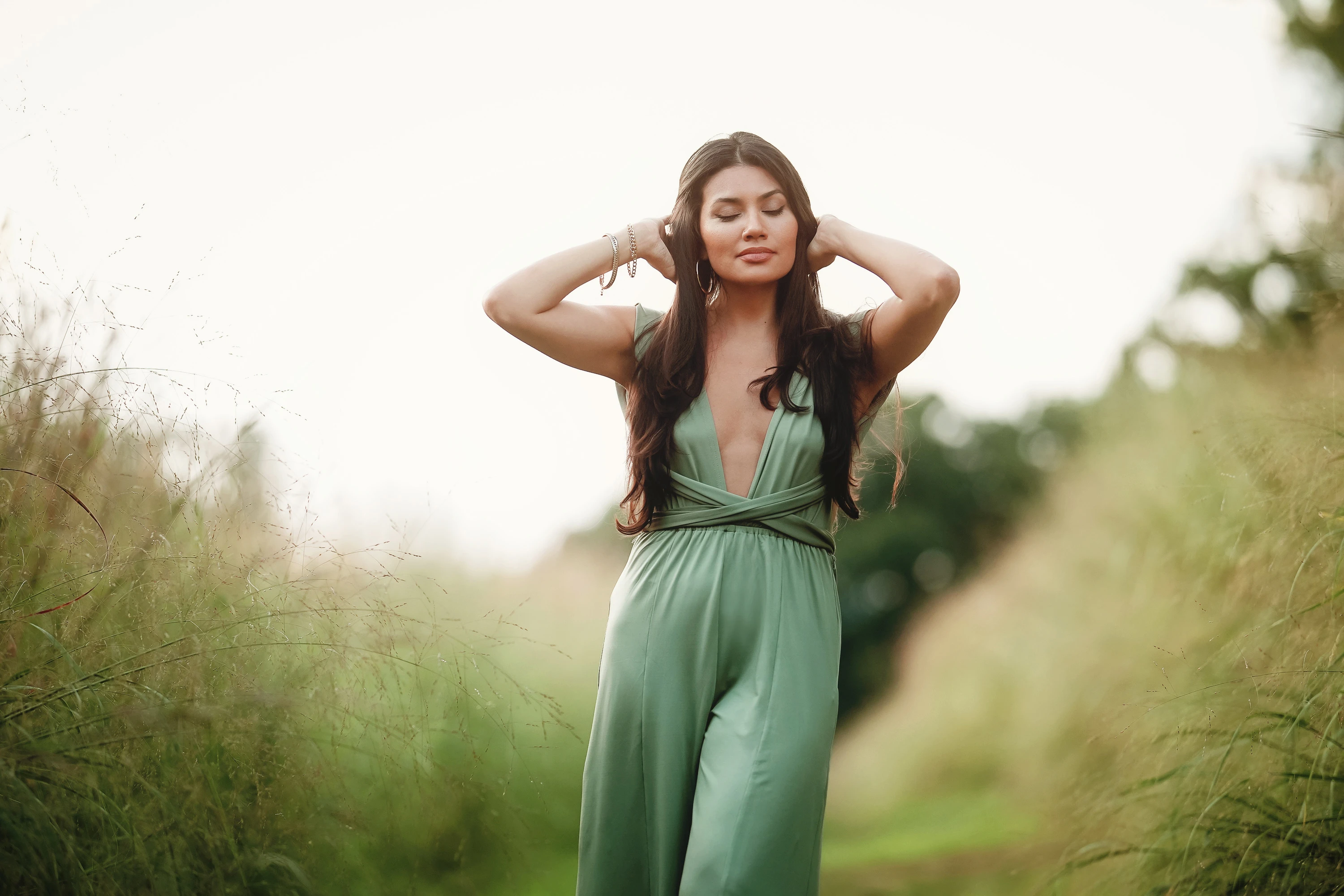 creative portrait of woman outdoors in green jumper