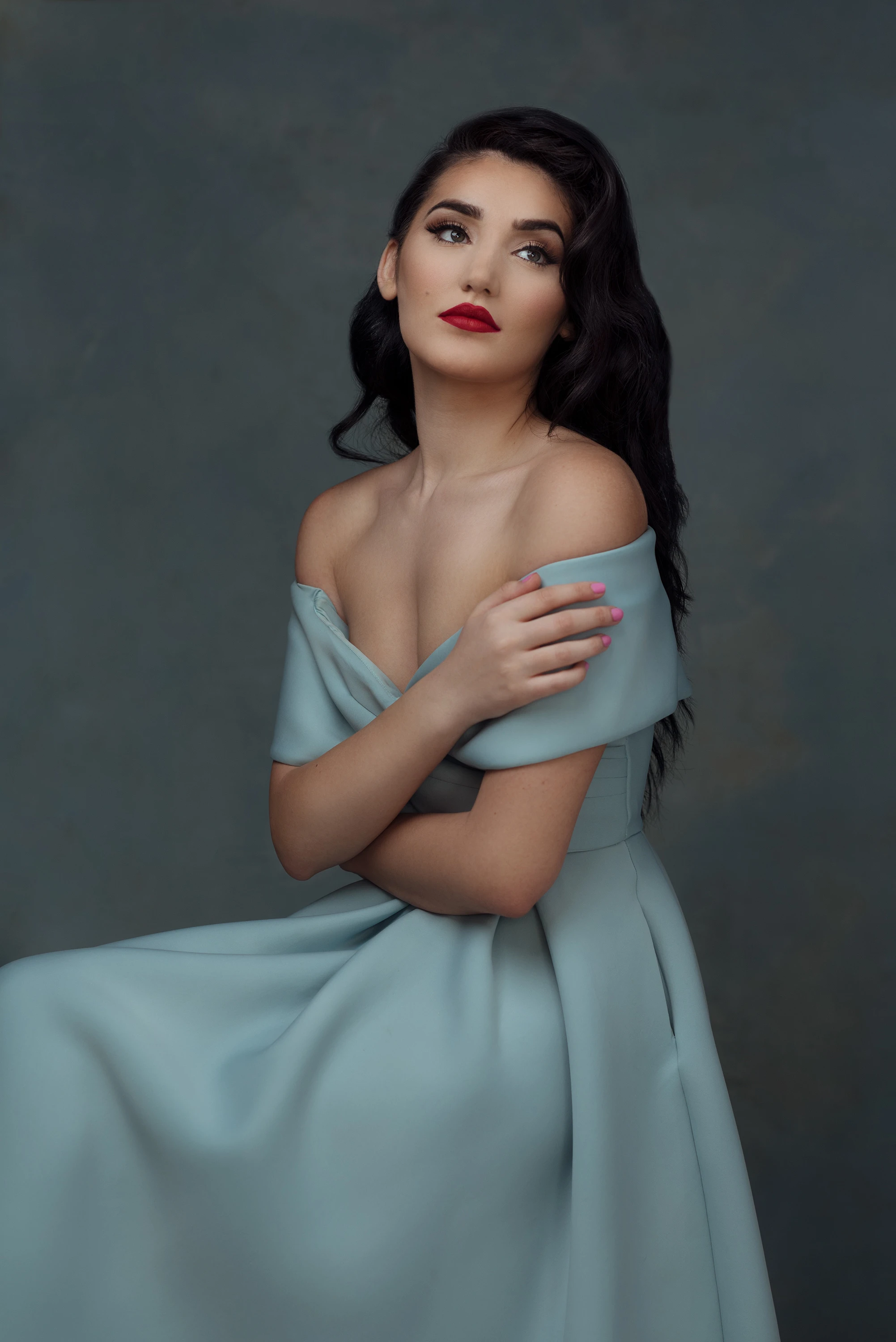 black hair woman posing for portrait in blue dress