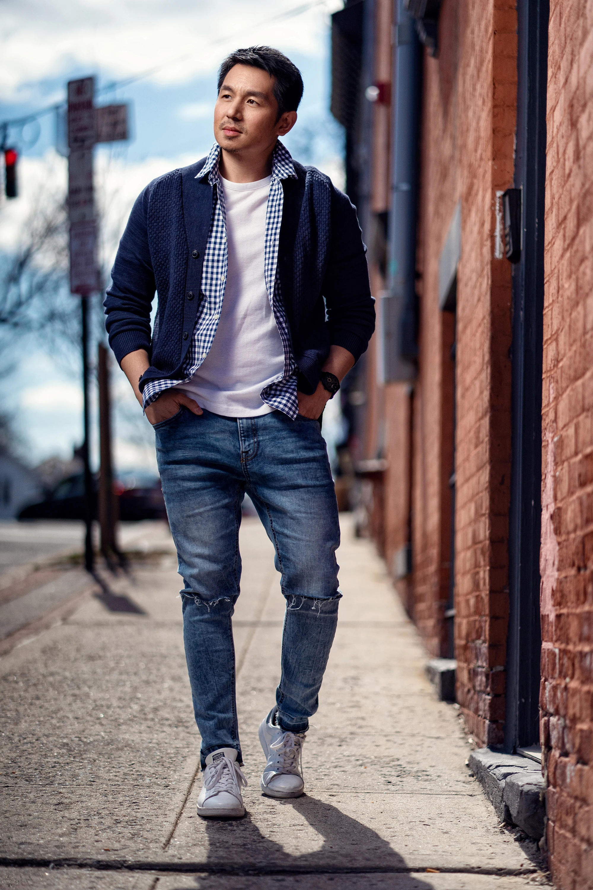 portrait of man outdoors on street in jeans and button down casual shirt