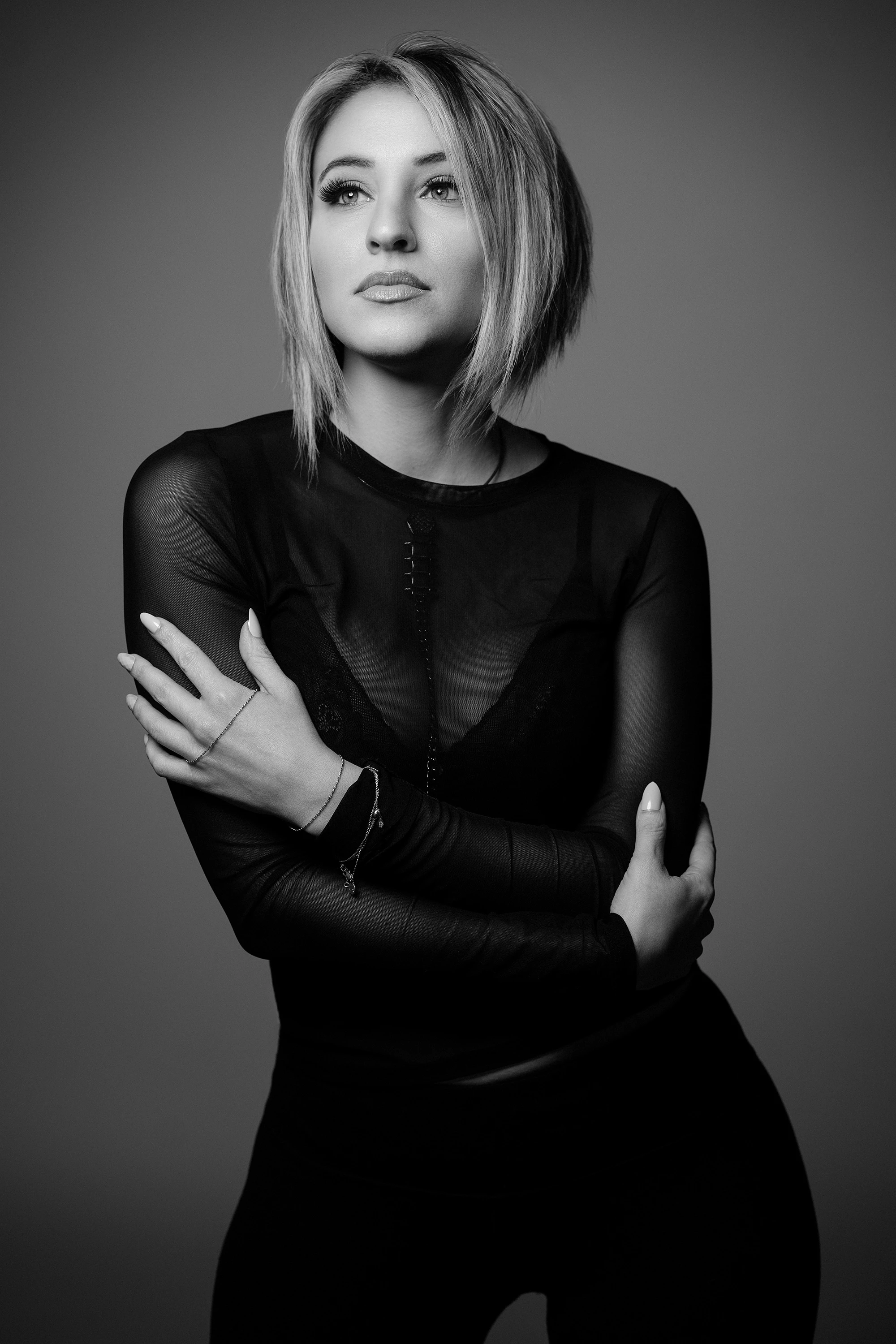 creative black and white portrait of blonde woman in black top