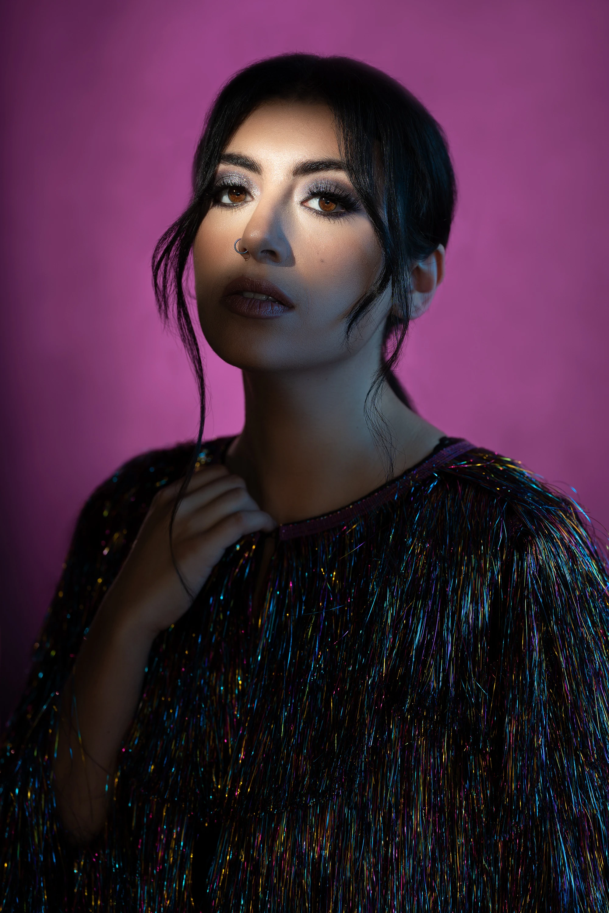 portrait of woman with pink photo backdrop