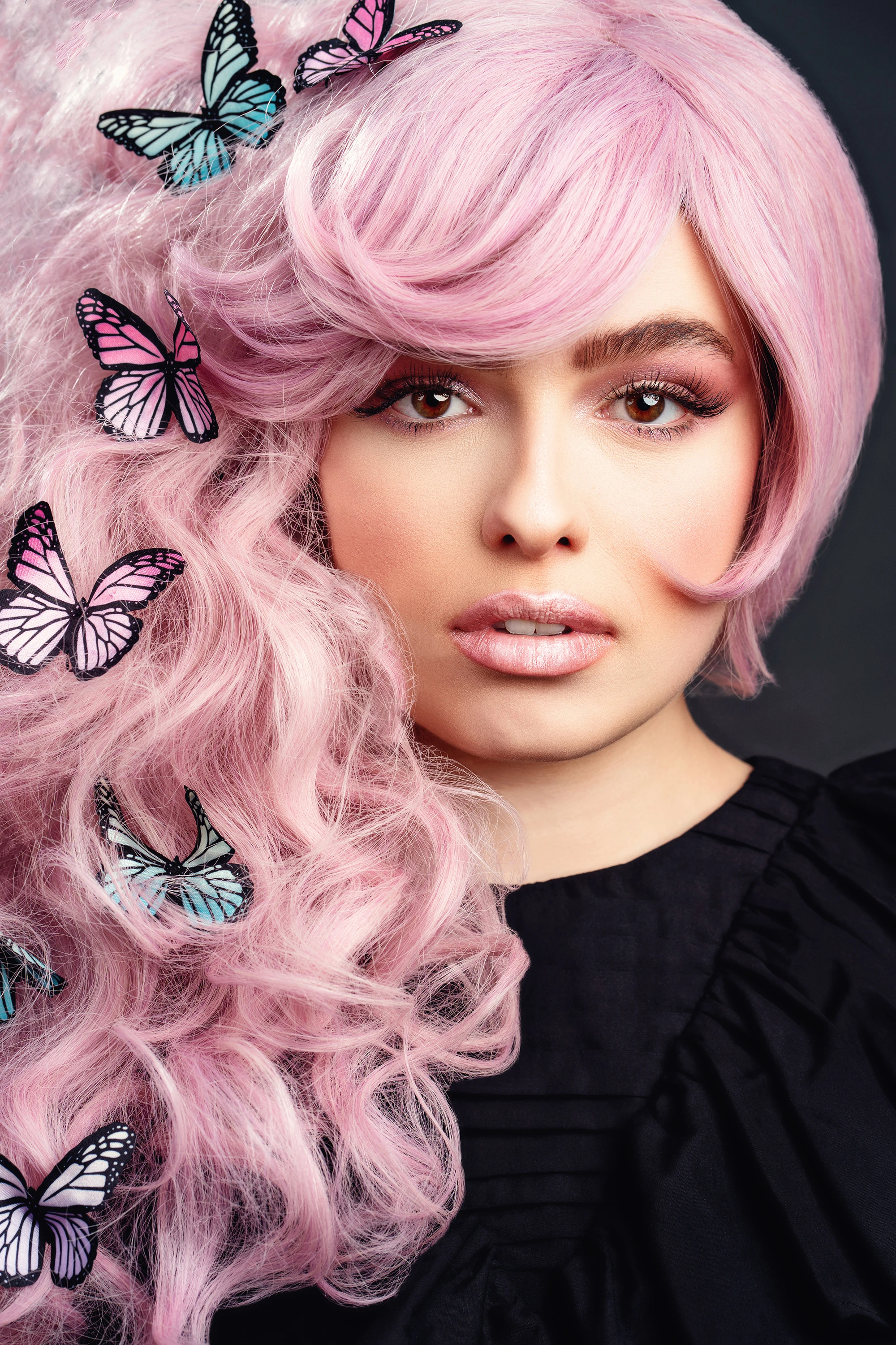 creative portrait of woman with pink hair and butterly clips