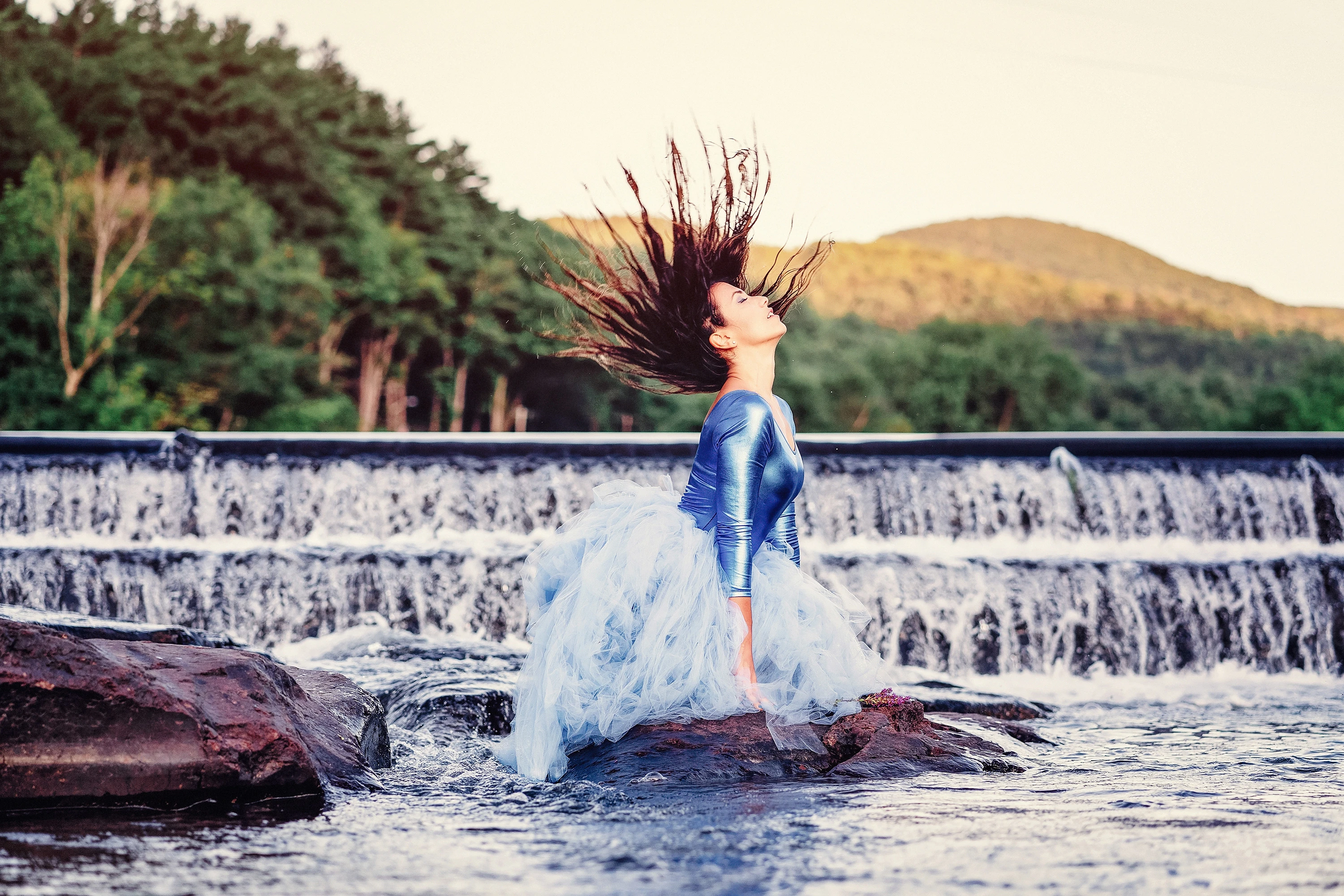Woman in dress posing in fountain
