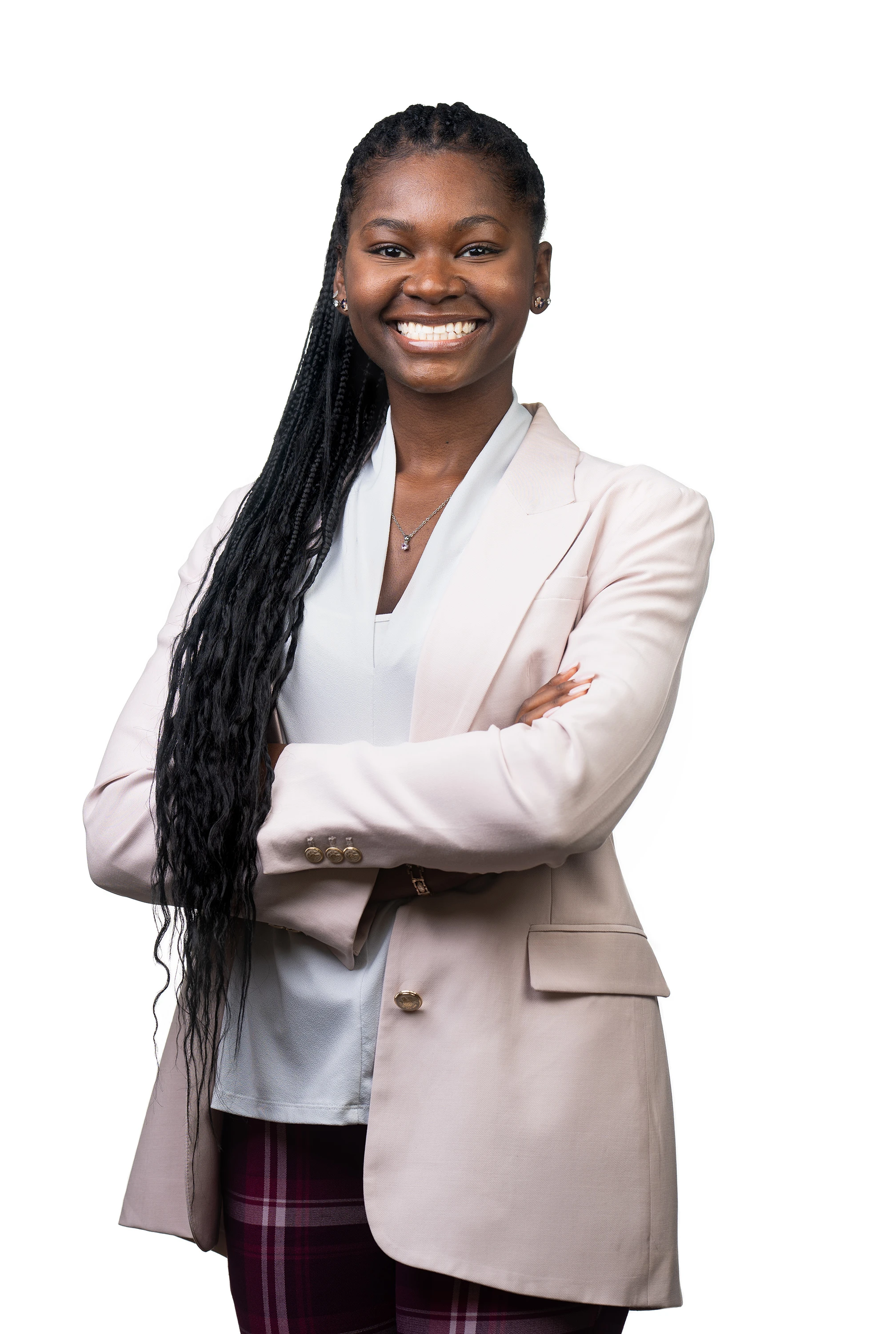 professional headshot of woman in blazer and plaid pants with white backdrop