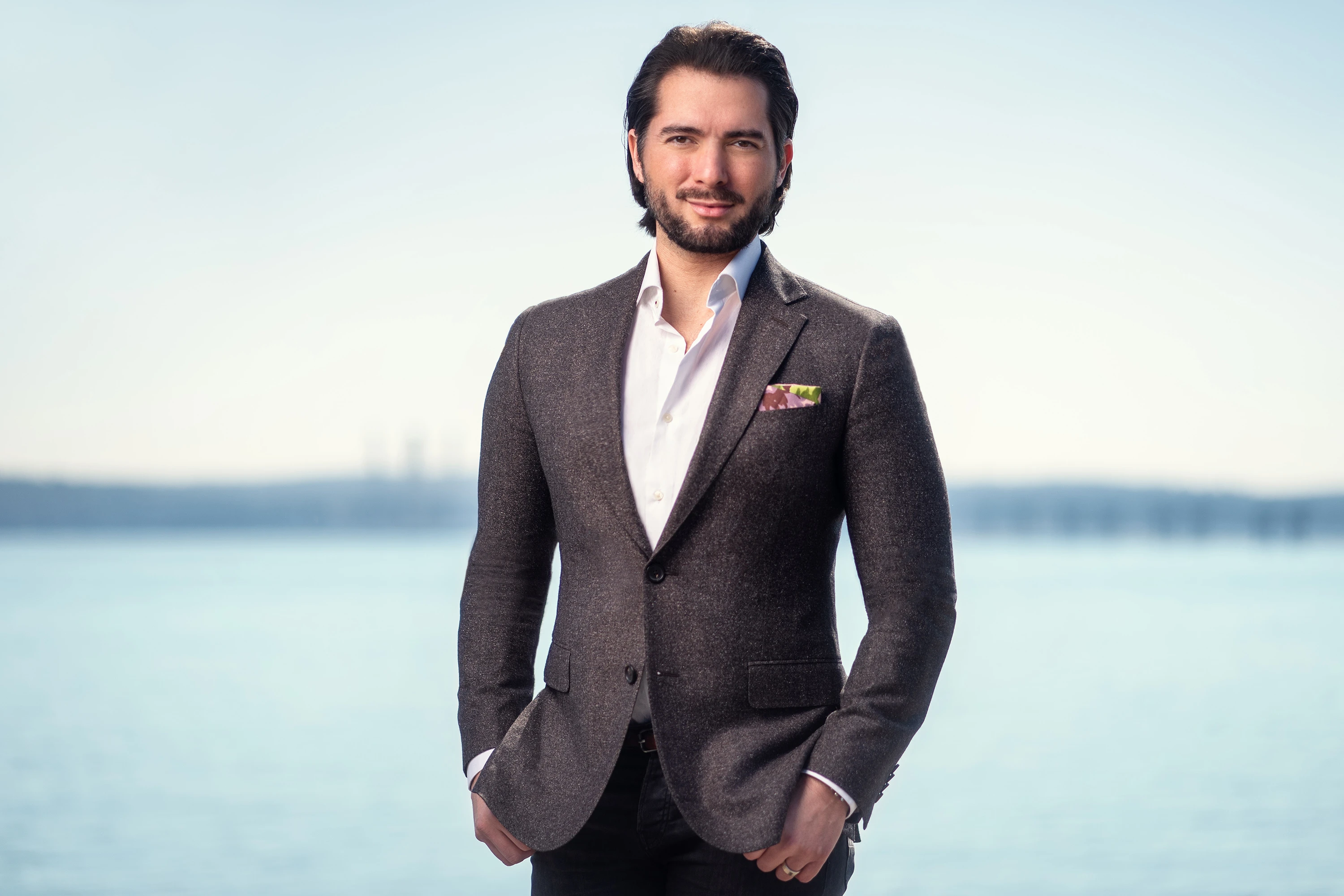 professional headshot of man in wool blazer posing with tappanzee bridge background