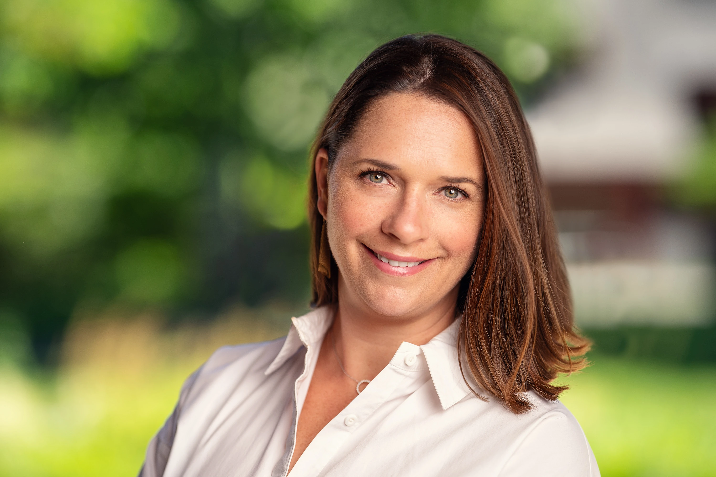 professional headshot of woman with short brown hair in white shirt