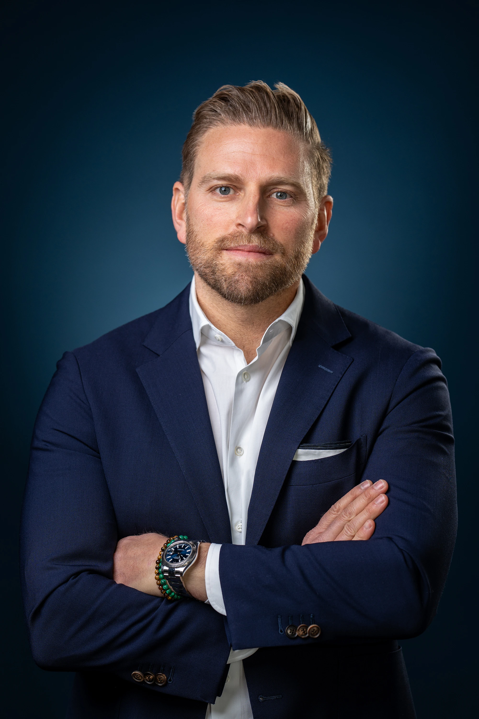 professional headshot of blonde hair man in blue suit