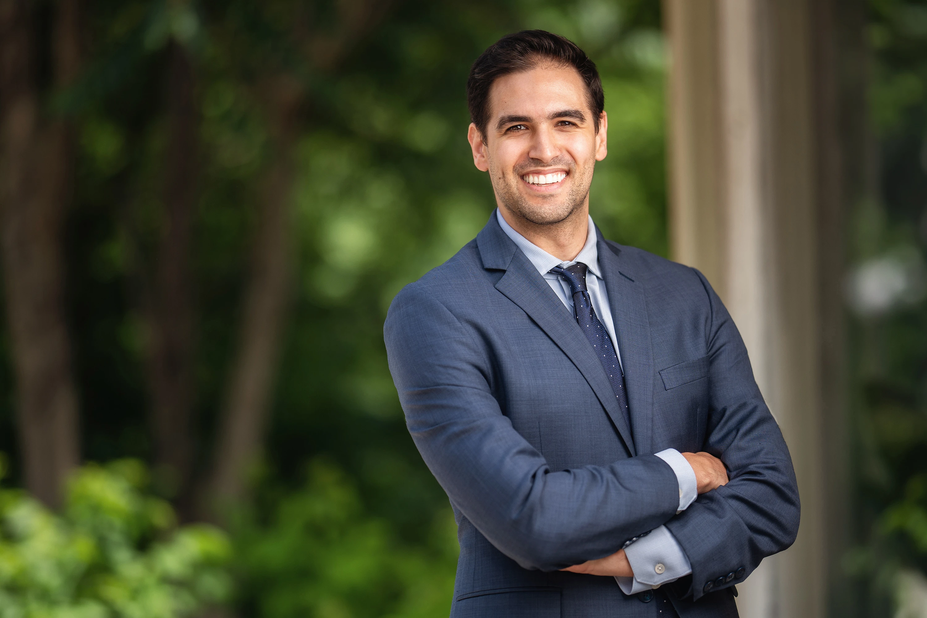 professional headshot of man in light blue suit