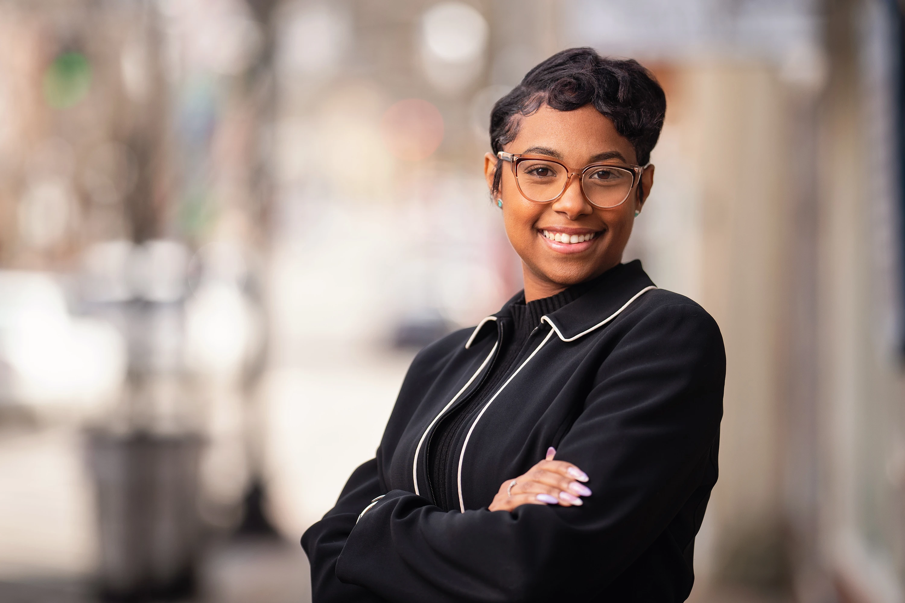 portrait of woman with updo hairstyle in black dress shirt and eye glasses